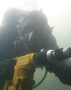 Diver using hydraulic rotary hammer drill