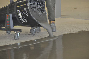 Pelican Transport Cart Pouring Self-Leveling Compound Onto Floor