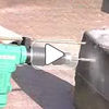Pneumatic rotary hammer drill making hole in reinforced concrete